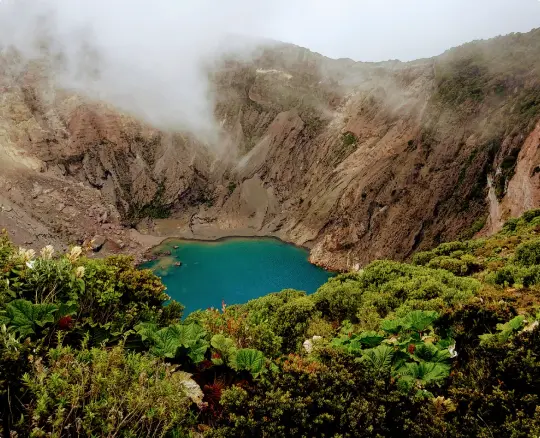 Costa Rica volcano with lake and fog