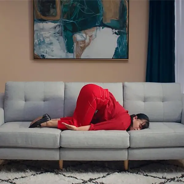 Woman sleeping on couch with her bottom up