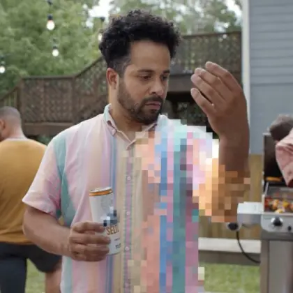 Man with pixelated hand with beer at the garden party