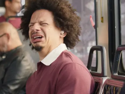 Man with crazy face looking top left from side